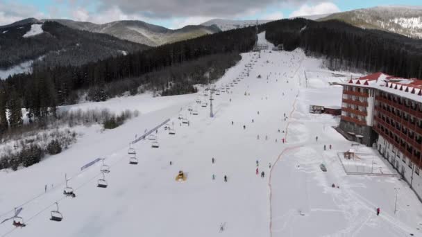 Aerial view on Lot of People Skiing on Ski Slopes near Ski Lifts on Ski Resort — Stock video