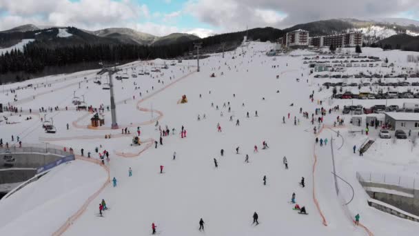 Aerial view on Lot of People Skiing on Ski Slopes near Ski Lifts on Ski Resort — 图库视频影像