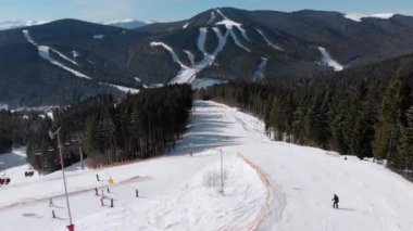 Aerial view Crowd of Skiers Skiing on Peak Ski Slope near Ski Lifts. Ski Resort