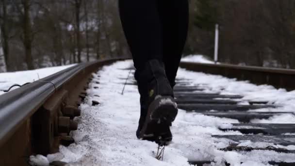 Legs of a Girl Walking along the Old Railway Tracks in Winter. Slow Motion — Stock Video