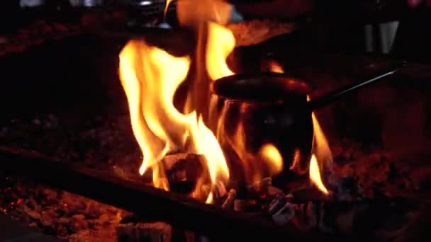 Turk with Coffee is Cooked on Fire while Standing on Coals Embraced by the Tongues of Red Flame — Stock video