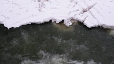 Waterfall Prut in the Winter. Rapid Flow of Water from a Mountain Creek and Stone Rapids with Snow