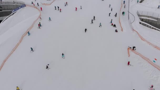 Aerial view on Lot of People Skiing on Ski Slopes near Ski Lifts on Ski Resort — Wideo stockowe