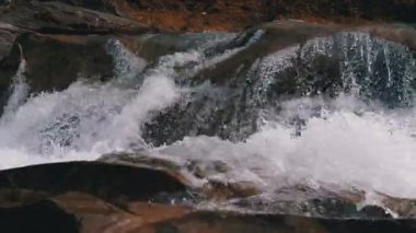 Mountain Creek and Stone Rapids with Snow. Rapid Flow of Water. Waterfall in the Winter. Slow Motion