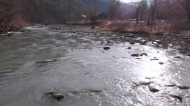 Flying over Wild Mountain River Flowing with Stone Boulders and Rapids