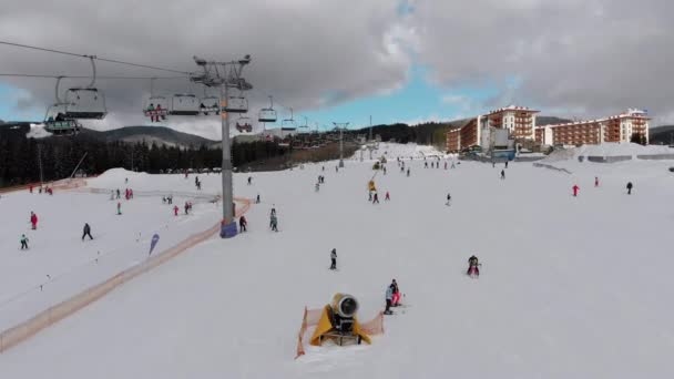 Aerial view on Lot of People Skiing on Ski Slopes near Ski Lifts on Ski Resort — Stockvideo