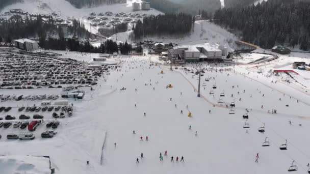 Aerial view on Lot of People Skiing on Ski Slopes near Ski Lifts on Ski Resort — стокове відео