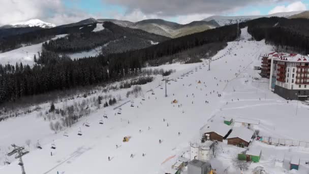 Aerial view on Lot of People Skiing on Ski Slopes near Ski Lifts on Ski Resort — Wideo stockowe