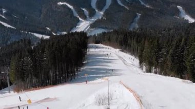 Aerial view Crowd of Skiers Skiing on Peak Ski Slope near Ski Lifts. Ski Resort