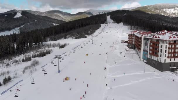 Aerial view on Lot of People Skiing on Ski Slopes near Ski Lifts on Ski Resort — стокове відео