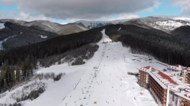 Aerial view on Lot of People Skiing on Ski Slopes near Ski Lifts on Ski Resort