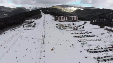 Aerial view on Lot of People Skiing on Ski Slopes near Ski Lifts on Ski Resort