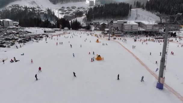 Aerial view on Lot of People Skiing on Ski Slopes near Ski Lifts on Ski Resort — Stock Video