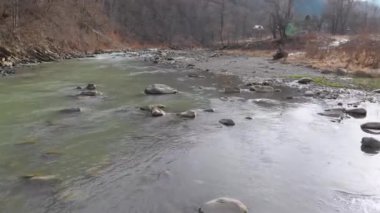 Flying over Wild Mountain River Flowing with Stone Boulders and Rapids