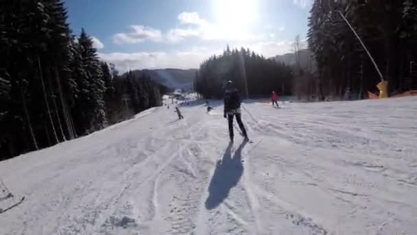 First-person view on Amateur Skiers Slide Down on Ski Slope at Ski