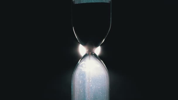 Hourglass on a Black Background. Close-up. Sand moves through the Sandglass — Stock Video