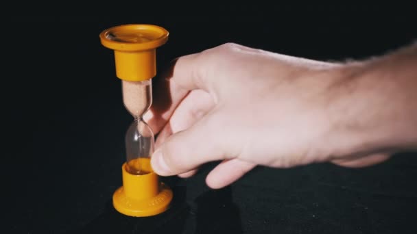 Hourglass on a Black Background. Close-up. Sand moves through the Sandglass — Stock Video