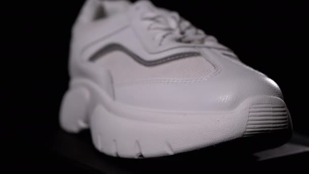 White New Sneaker Rotates on a Black Background. Sport Female Shoes — Stock Video