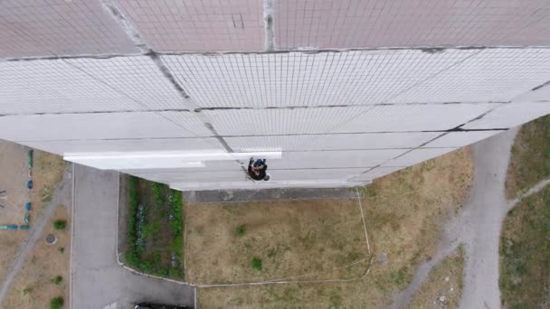 Alpinismo industrial. Vista aérea. Trabajo en el edificio aislante exterior con espuma de poliestireno — Vídeo de stock