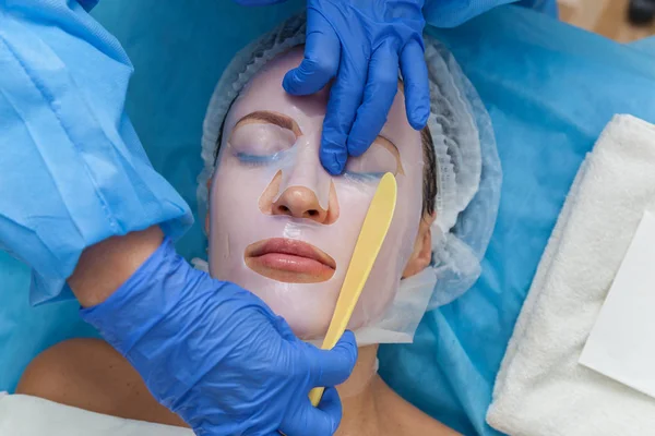woman in mask cosmetic procedure