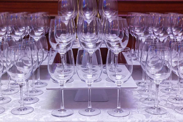 Empty glasses stand on a white table.Empty glasses