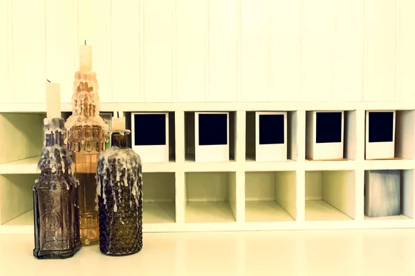 Botellas Con Una Vela Sobre Una Mesa Blanca —  Fotos de Stock
