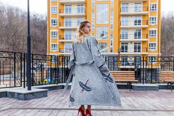 Красивая женщина в пальто на городском фоне — стоковое фото
