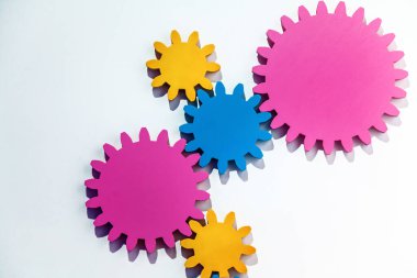 Multi-colored cogwheels on the background