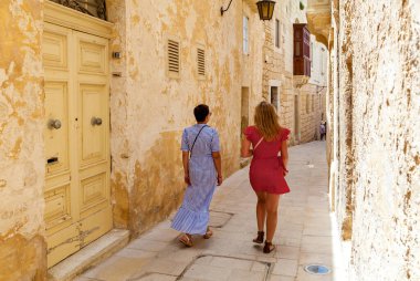 Two women are strolling the ancient city streets