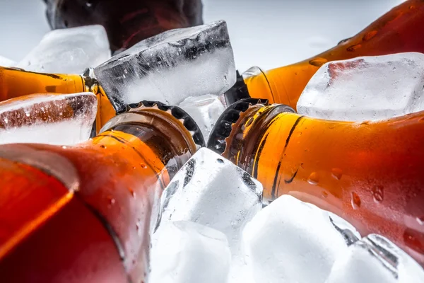 Soda buzdolabında buz üzerinde bir açık renkli cam şişelerde