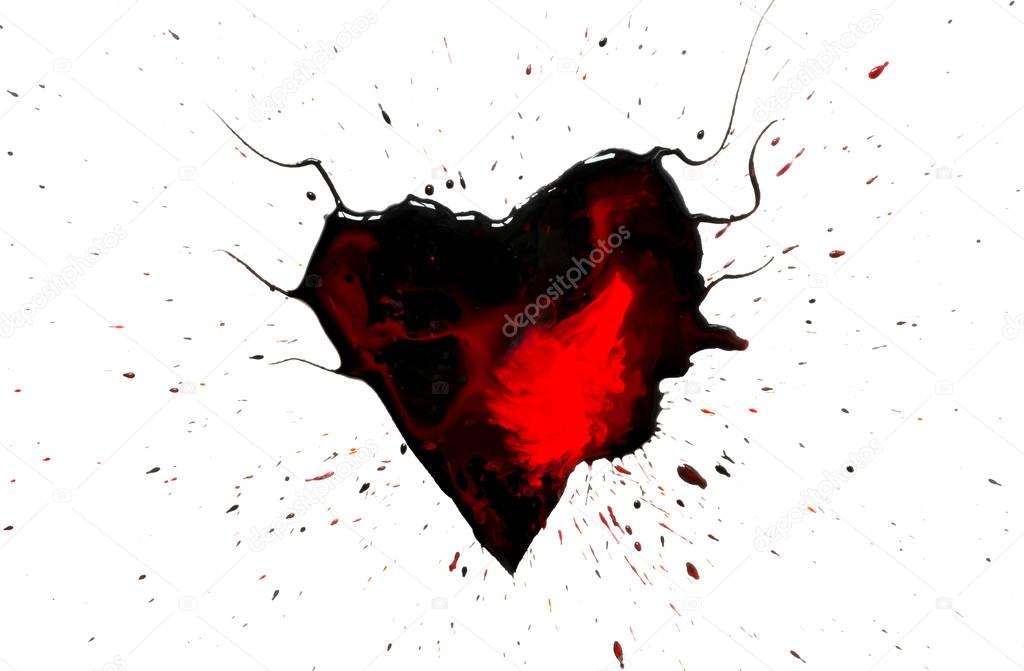 Black heart with horns with red drops and stains and black paint spray around isolated on white background.