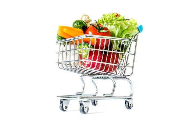 Shopping cart with fresh vegetables close-up isolated on white background — Stock Photo, Image