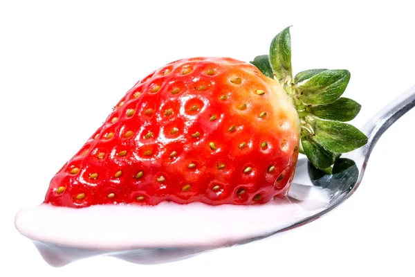 Strawberry on a spoon with strawberry pink yogurt cream close-up isolated on white background — Stock Photo, Image