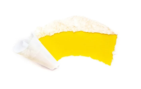 A hole in white paper with torn edges isolated on a white background with a bright yellow color paper background inside. Good paper texture. — Stock Photo, Image