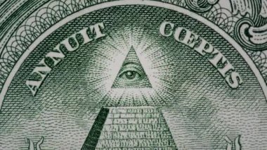 1 Amerikan Doları 'na ait bir makro banknotun piramitli 4k' lik yaratıcı videosu ve üzerinde ışıldayan bir mason gözün etkisi. Piramit, 1 Amerikan Doları 'na yakın çekim..