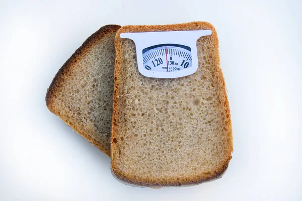 Imaginary weighing scales made of bread slice isolated on white background. Diet concept to promote healthy eating and weight management.