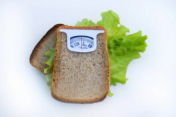 Imaginary weighing scales made of bread slice isolated on white background. Diet concept to promote healthy eating and weight management. — Stock Photo, Image