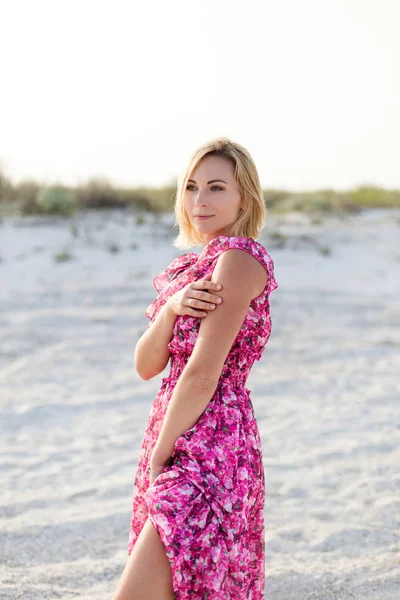 Young beautiful woman in rose dress in the sea, beauty, smile, portrait, summer.