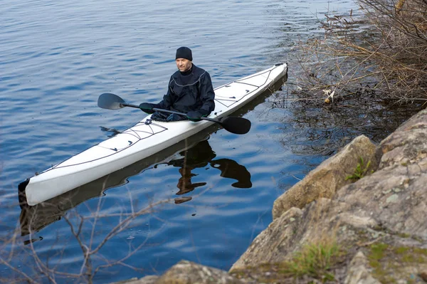 Un hombre en un kayak blanco cerca de la orilla del río de la ciudad09 —  Fotos de Stock