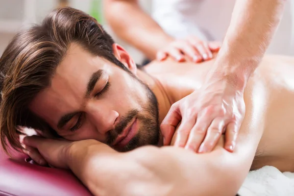 Young Man Enjoying Massage Spa Treatment — Stock Photo, Image