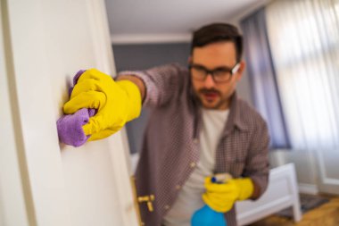 Genç adam takıntılı bir şekilde daireyi temizliyor..