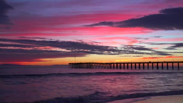 カリフォルニア中央海岸に沿って撮影された豪華な赤いオレンジ色の夕日の海岸線ベンチュラ桟橋遠く — ストック動画