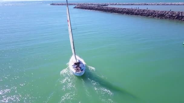 Good Aerial Small Sailboat Heading Out Harbor — Stock Video
