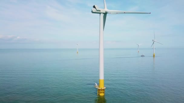 イングランドの海岸沖で 風車やタービンの上空で注目すべき上昇するドローン — ストック動画