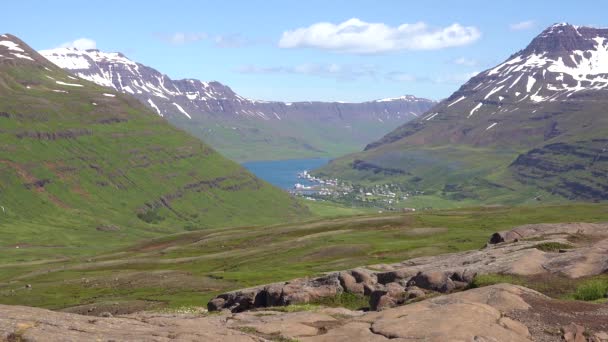 高い山のフィヨルドの撮影を確立するアイスランドでは セイディフジョドゥールの村は遠く — ストック動画