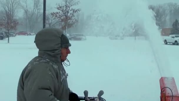 在冬天的暴风雨中 一个人在邻居们铲雪的时候用了一个吹雪机 — 图库视频影像