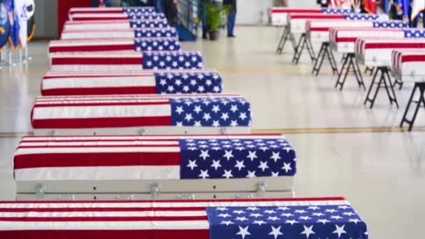 2018年 在一座军用机库中展出悬挂国旗的美军阵亡士兵的棺材 — 图库视频影像