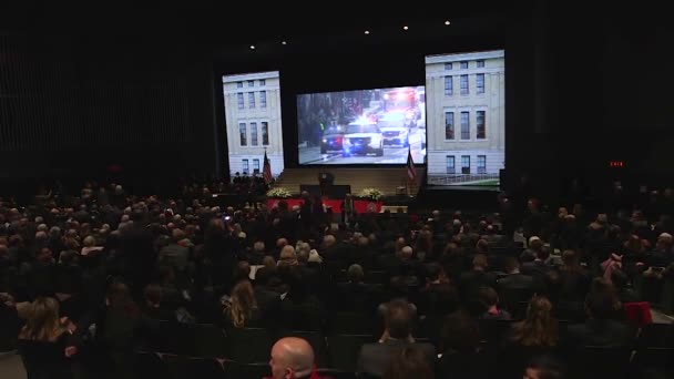 格伦的葬礼车队沿着一条城市街道行进 并被投射到众多的观众面前 — 图库视频影像