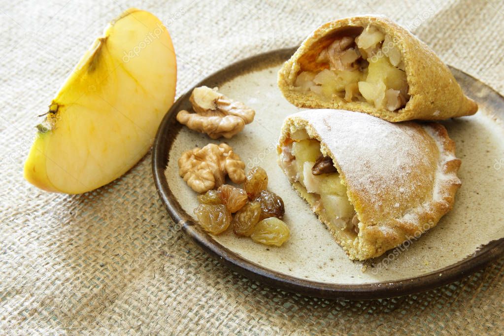 Russian pirozhki, baked patties or pies on basket