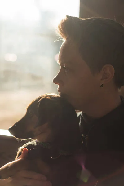 Woman and dog by the window on quarantine — Stock Photo, Image